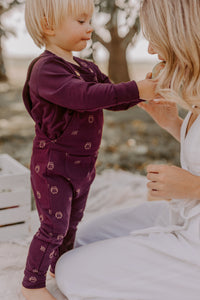 Evolutionary aubergine overalls with owl pattern